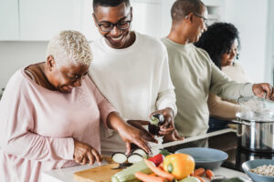 Happy black family cooking inside kitchen at home - Father, daug