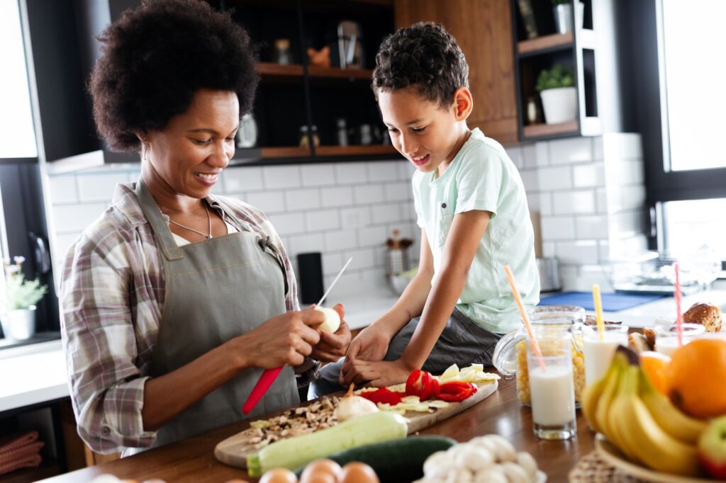 A mother and child prepare a healthy meal in their kitchen