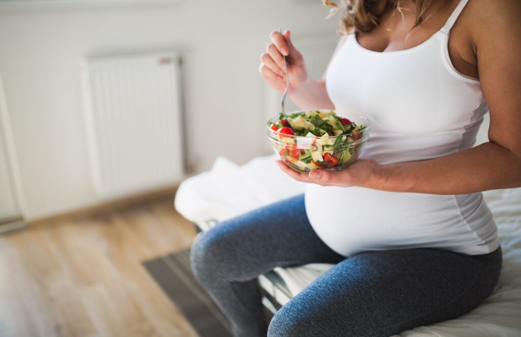 Pregnant woman eating healthy food