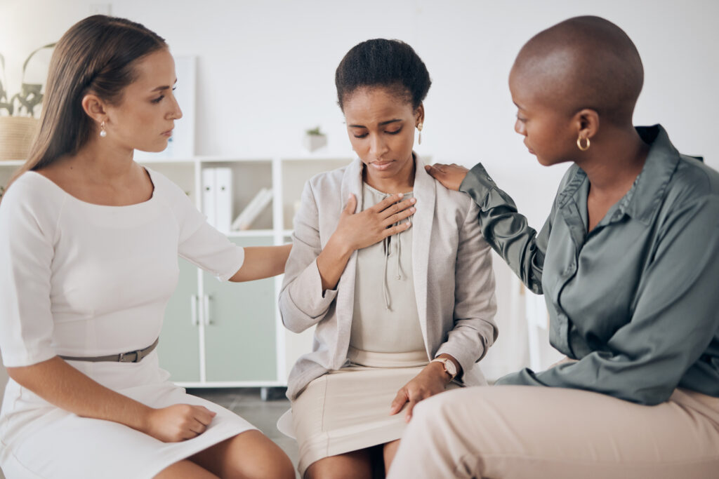 Two women comfort a woman by listening and affirming her.