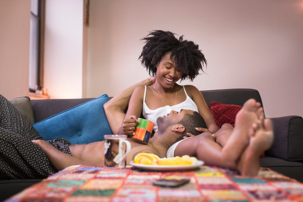 Couple relaxing on sofa in living room