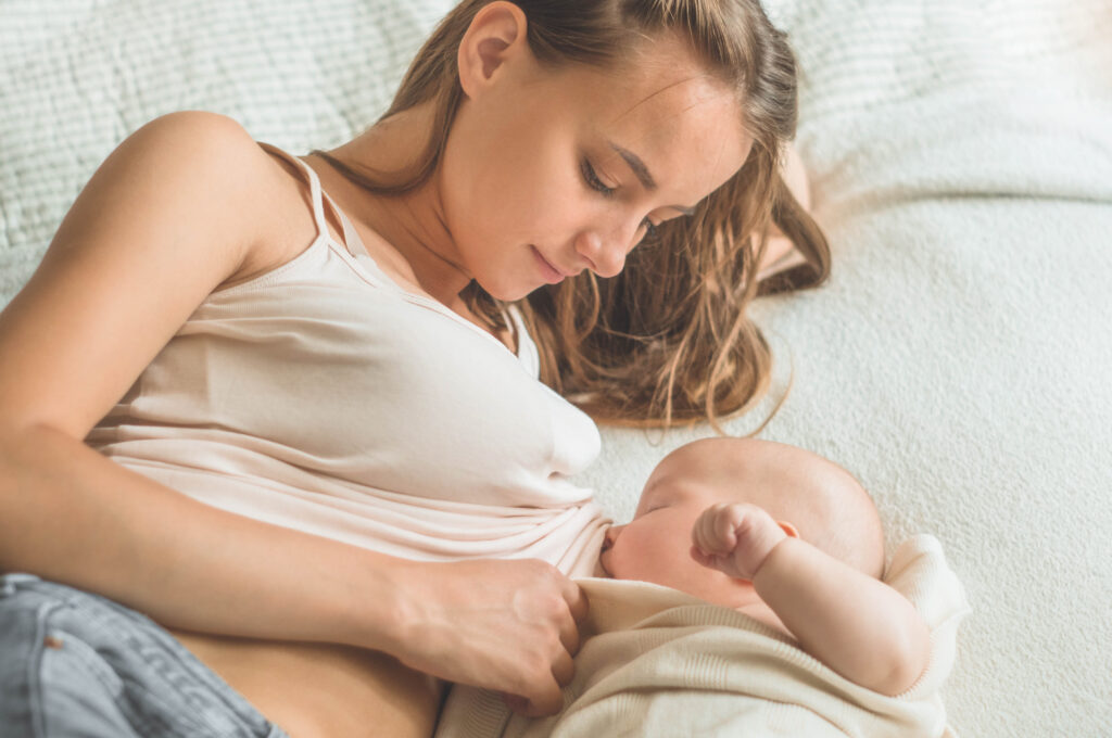 Teen mom breastfeeds her newborn baby.