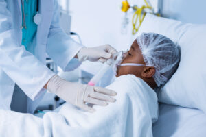 Doctor placing an oxygen mask on a child suffering from respiratory illness.