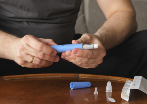 Man holding an Ozempic injection.