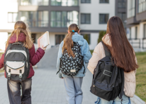 Students with backpacks walking to school.