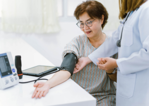 Woman having her blood pressure checked by a healthcare provider.
