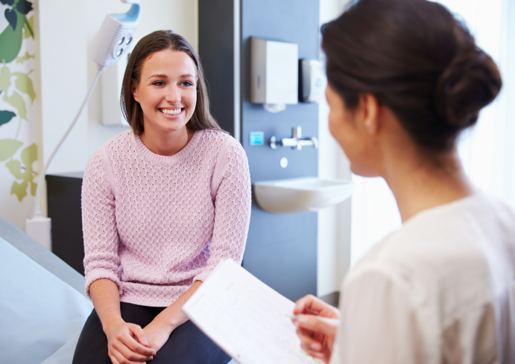 Woman talking with a health care provider during a medical visit
