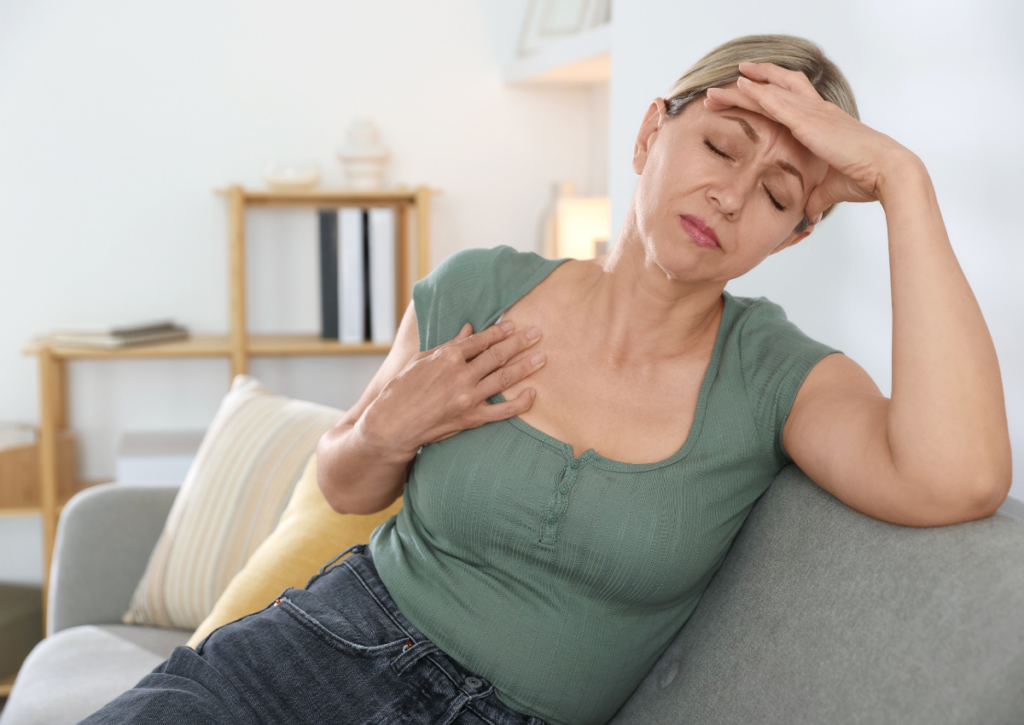 Woman experiencing discomfort from a hot flash during menopause.