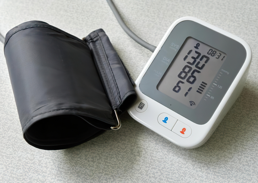 Digital blood pressure monitor with an arm cuff.